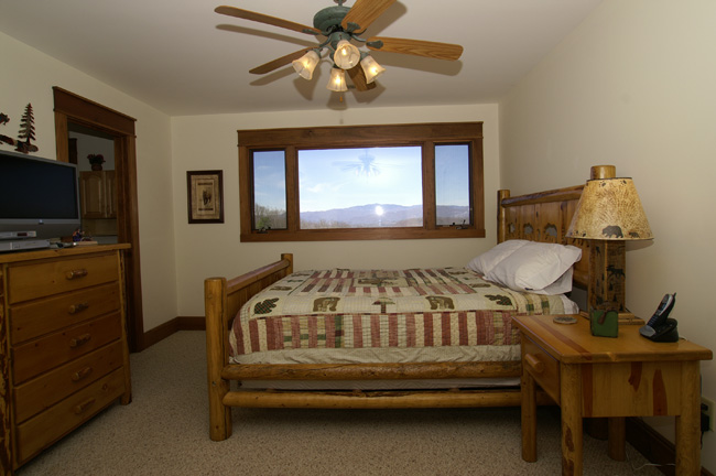 A Master Bedroom in a cabin with a great mountain view